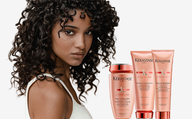 Kerastase Discipline model with hair care for frizzy hair.