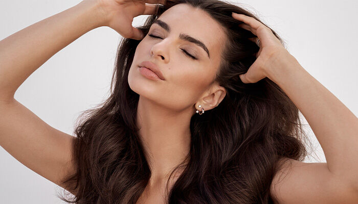 model runs fingers through hair