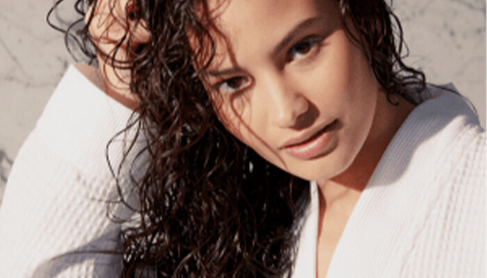 model with frizz taming serum