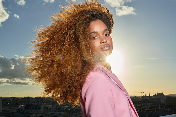 person with curly coloured hair