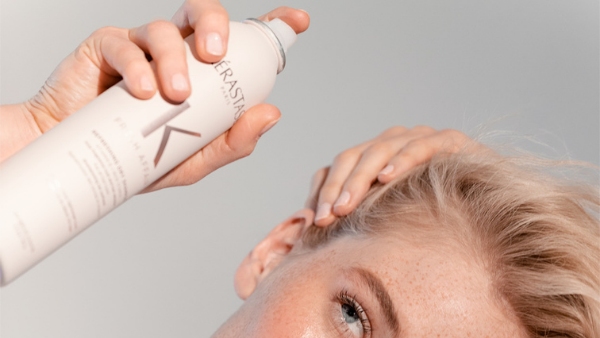 model spraying fresh affair in blonde hair